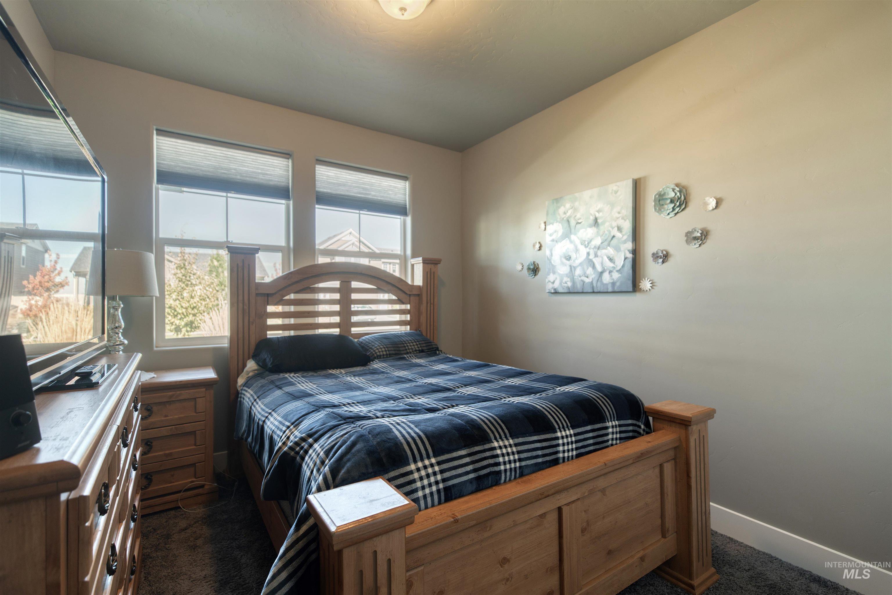 11913 West Piazza Street Nampa, ID 83686 - Photo 16 of 50 Bedroom featuring dark colored carpet and baseboards