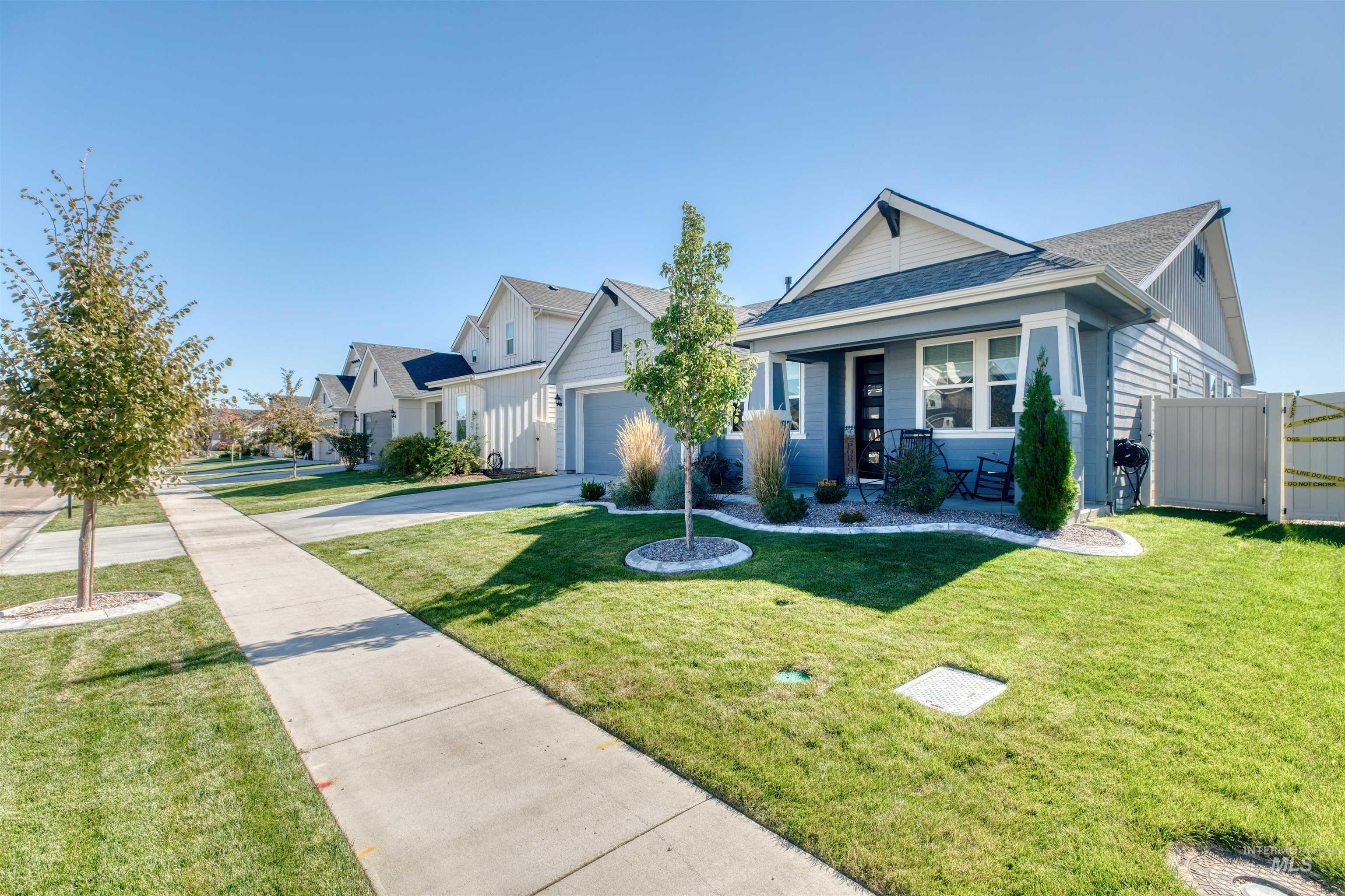 11913 West Piazza Street Nampa, ID 83686 - Photo 2 of 50 Bungalow-style home featuring a shingled roof, concrete driveway, a gate, and a residential view