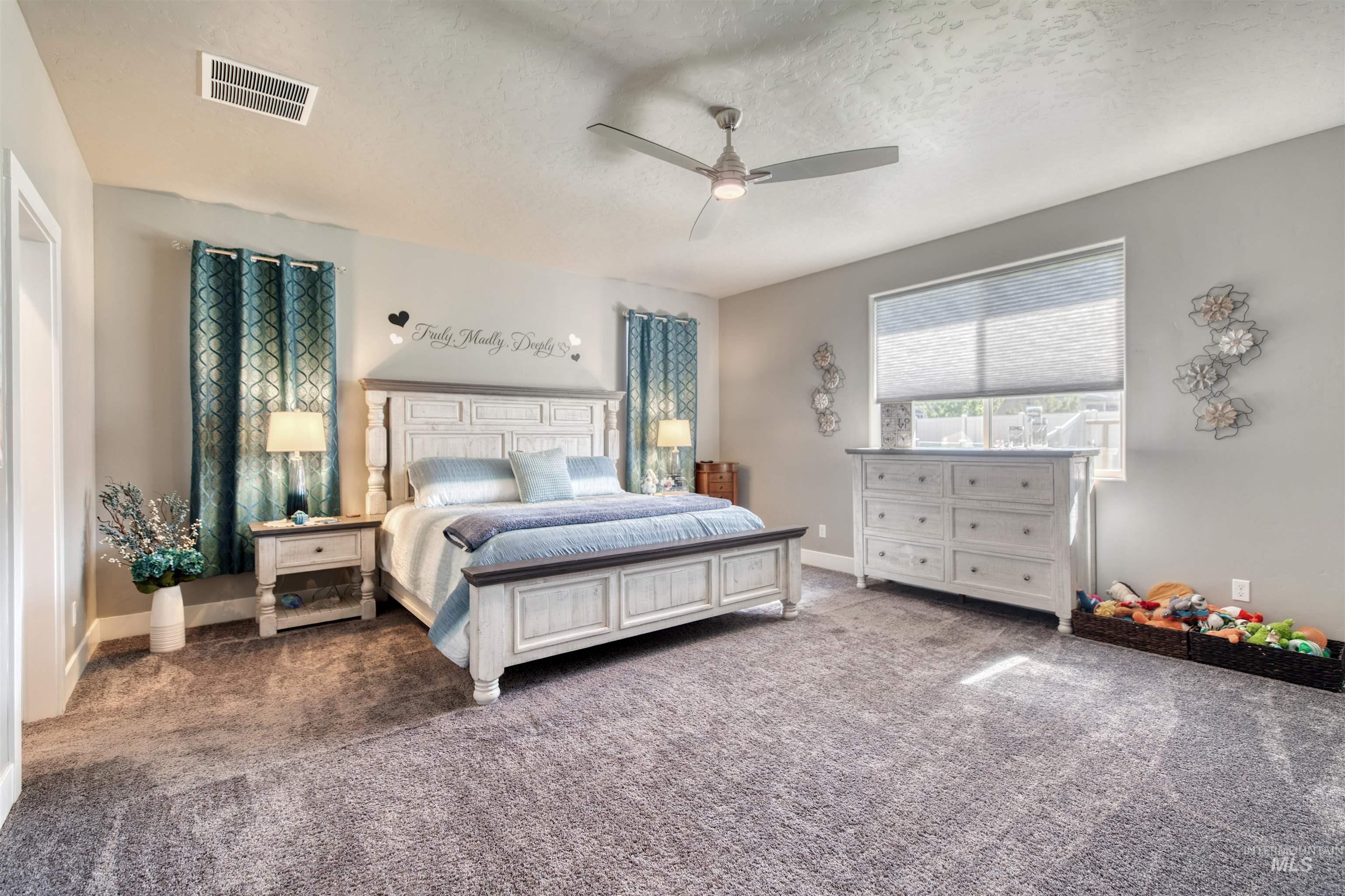 11913 West Piazza Street Nampa, ID 83686 - Photo 19 of 50 Bedroom featuring a textured ceiling, carpet floors, and ceiling fan