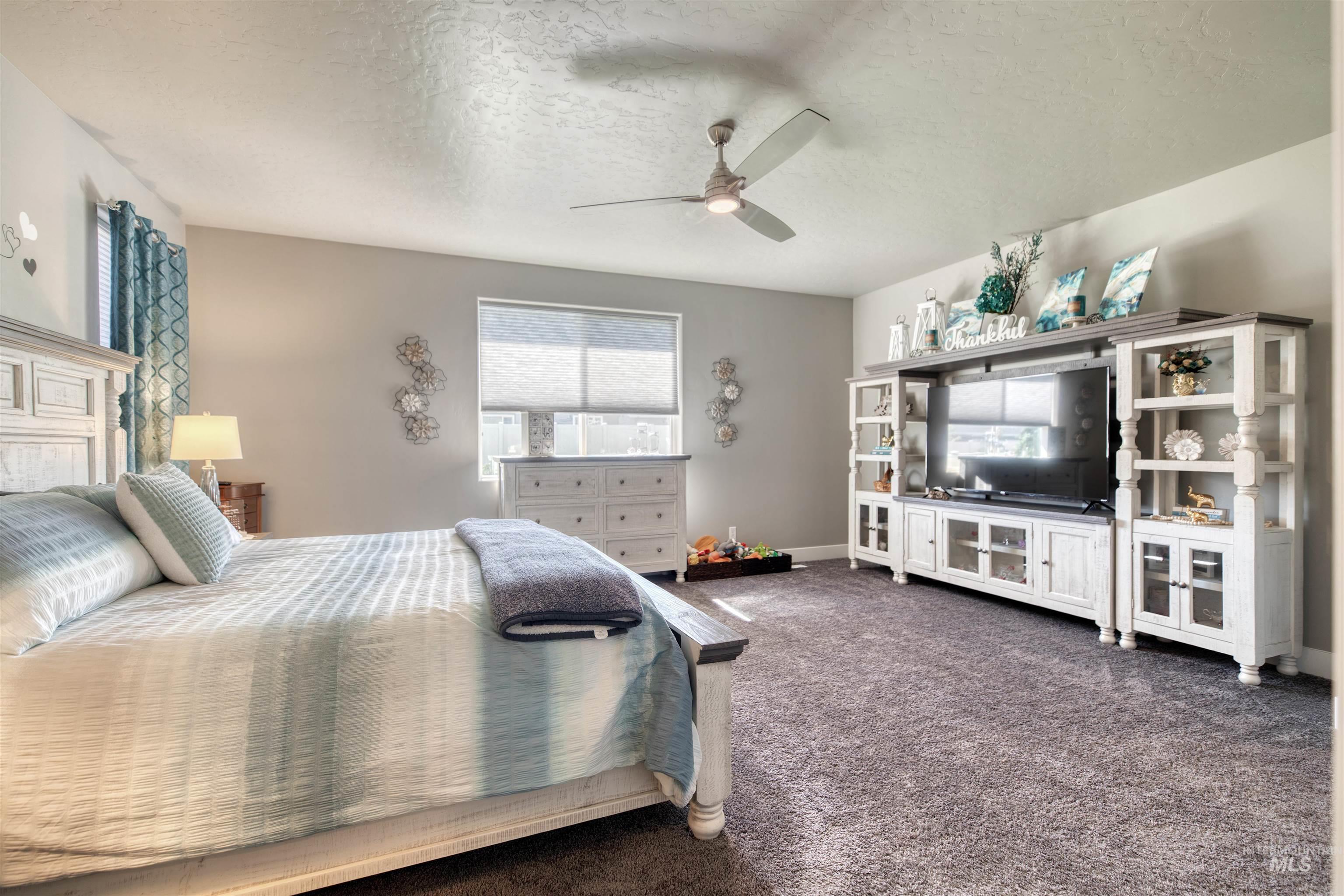 11913 West Piazza Street Nampa, ID 83686 - Photo 26 of 50 Carpeted bedroom with a textured ceiling and a ceiling fan