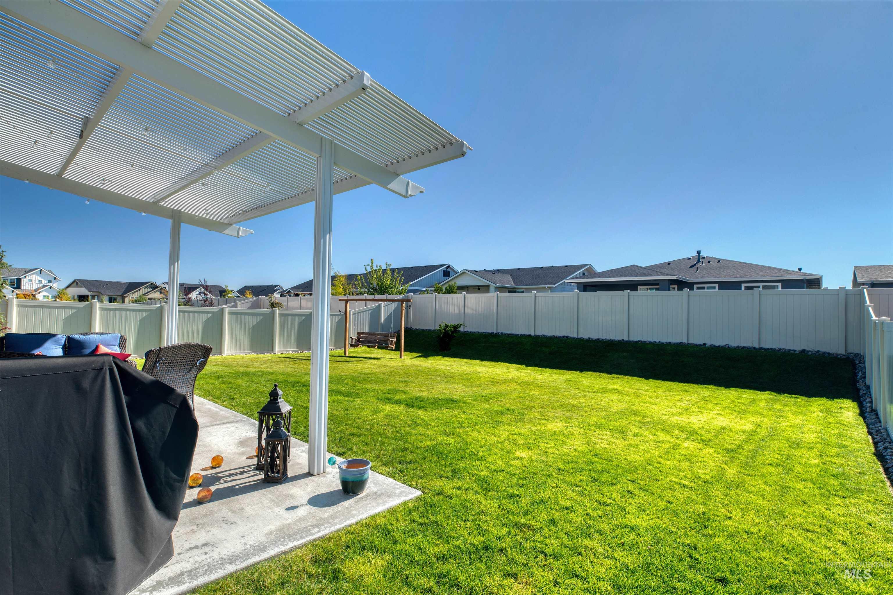 11913 West Piazza Street Nampa, ID 83686 - Photo 31 of 50 Fenced backyard with a residential view and a patio area