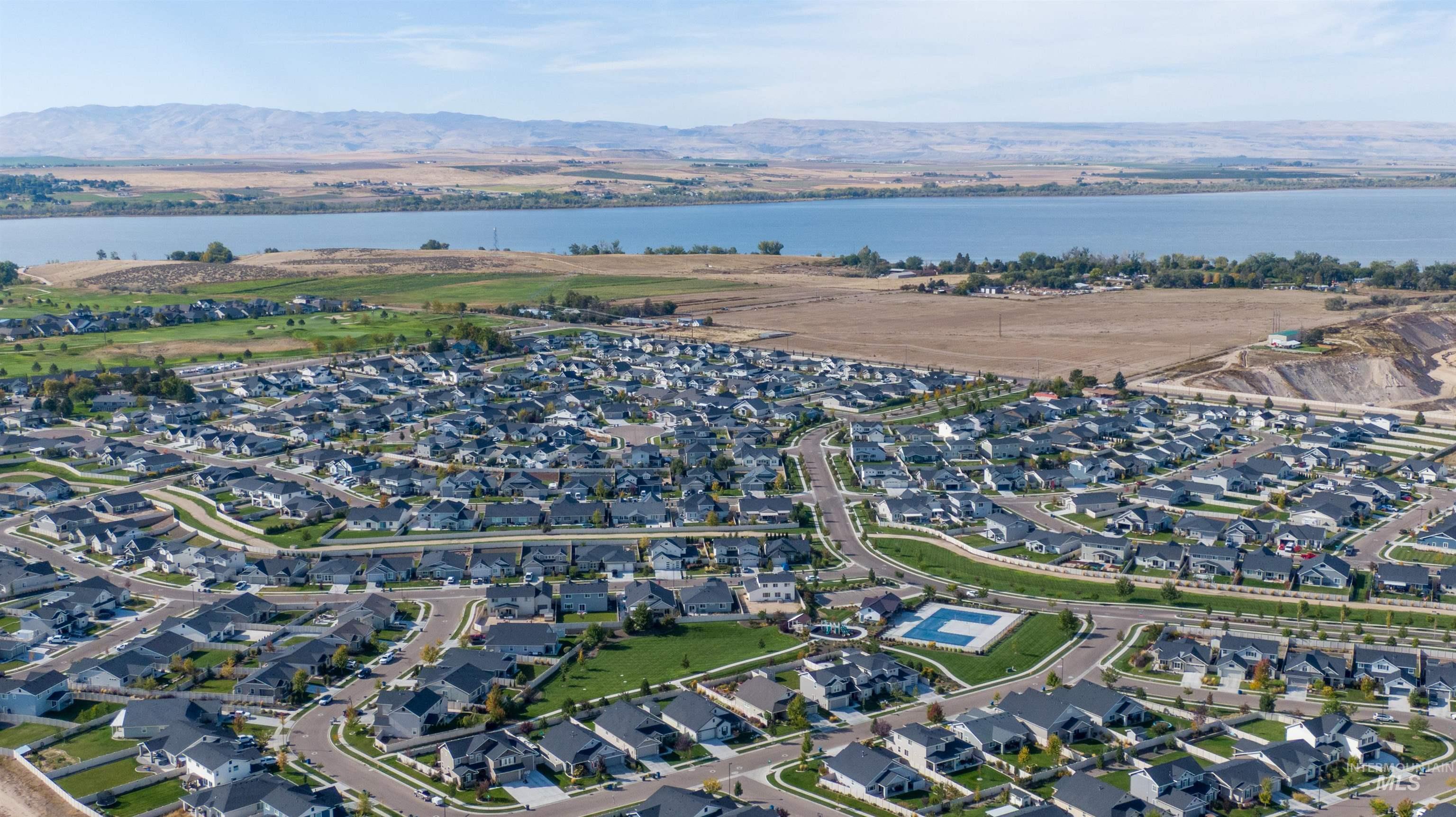 11913 West Piazza Street Nampa, ID 83686 - Photo 46 of 50 Aerial view of property and surrounding area featuring nearby suburban area and a water and mountain view