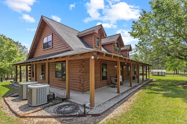 a view of a house with a yard and furniture