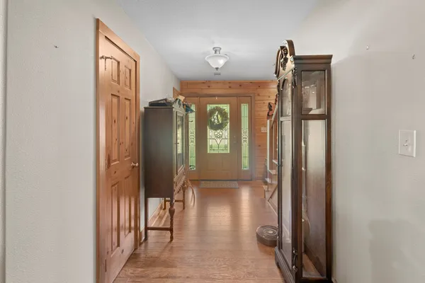 a living room with furniture a fireplace and a floor to ceiling window