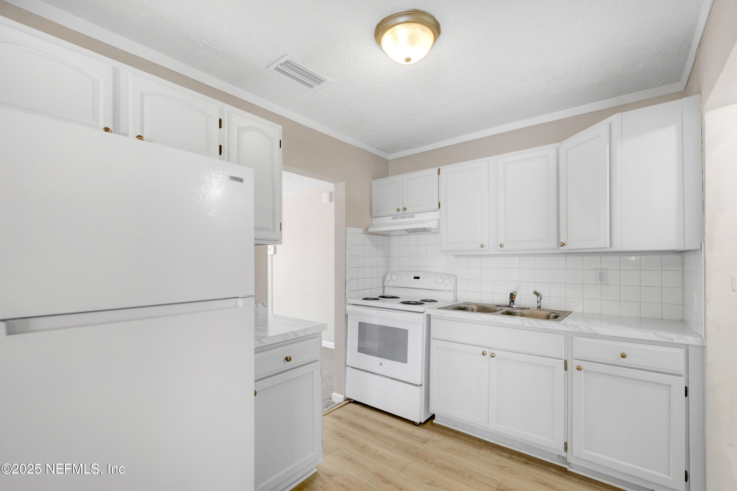 2971 West 16th Street Jacksonville, FL 32254 - Photo 4 of 21 a kitchen with cabinets appliances a sink and a window