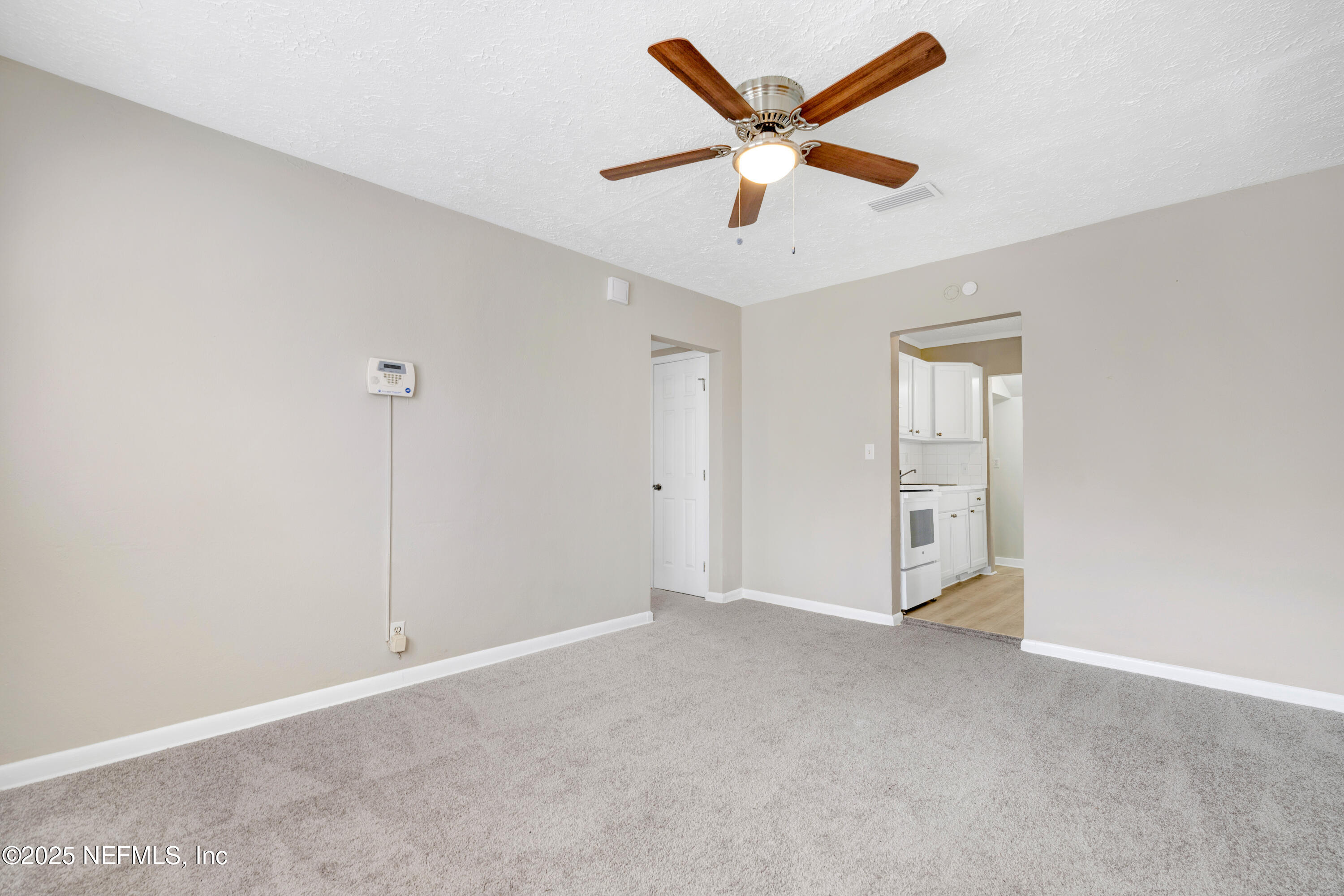 2971 West 16th Street Jacksonville, FL 32254 - Photo 8 of 21 an empty room with a ceiling fan and window