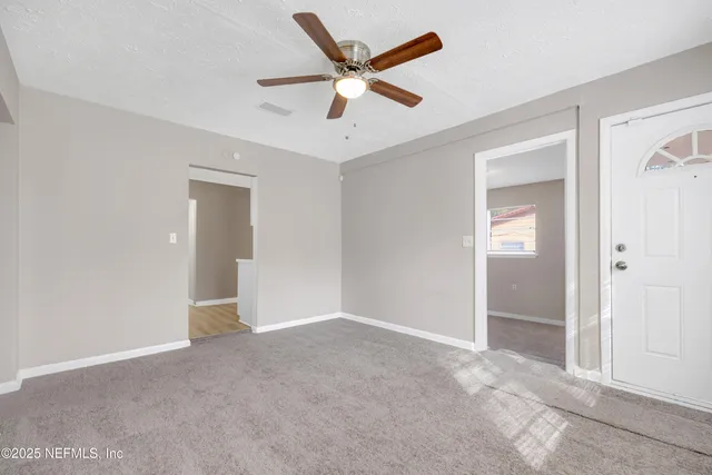 a view of an empty room and closet area
