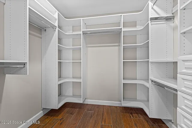 a view of walk in closet with empty racks