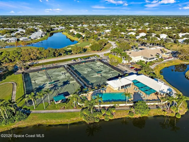 a view of a swimming pool with outdoor seating and a garden