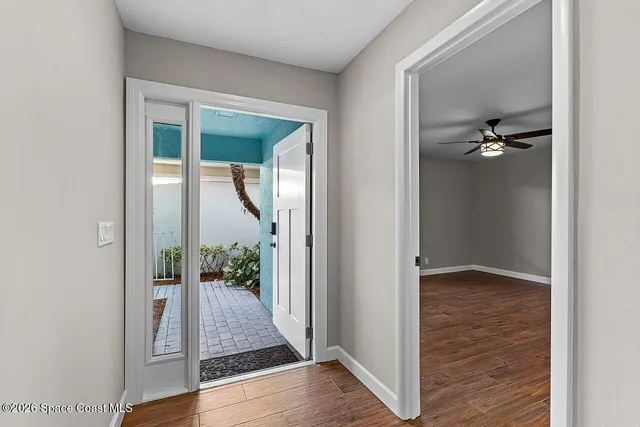hallway view with wooden floor and front door