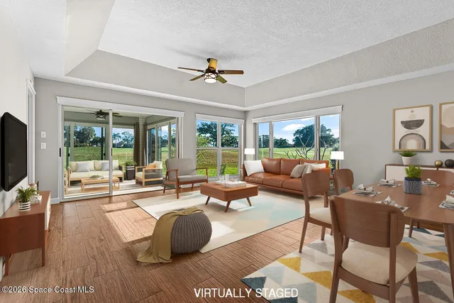 a living room with patio furniture and a flat screen tv