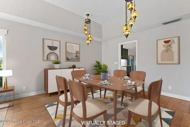 a view of a dining room with furniture and wooden floor