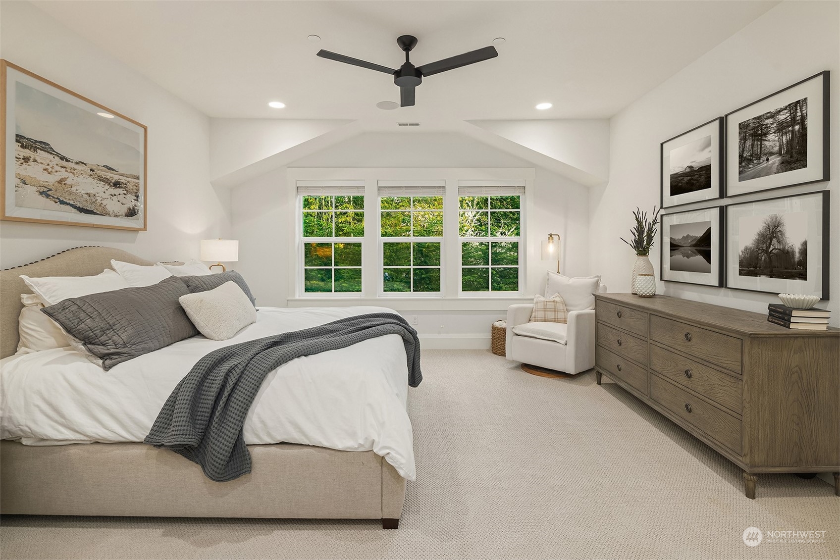 202 Woodhaven Place Edmonds, WA 98020 - Photo 26 of 40 a spacious bedroom with a bed a couch and a window
