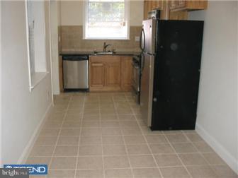 537 Wharton Street Philadelphia, PA 19147 - Photo 3 of 11 a kitchen with granite countertop a refrigerator and a sink