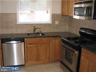 537 Wharton Street Philadelphia, PA 19147 - Photo 4 of 11 a kitchen with granite countertop a stove sink and cabinets