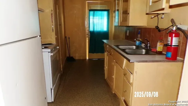 a kitchen with a sink and a refrigerator