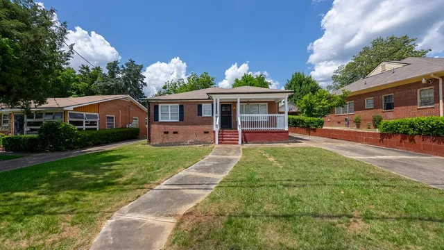 a front view of house with yard and green space