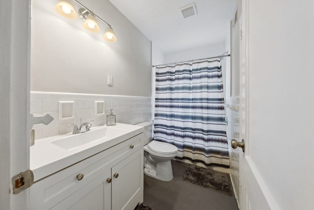 3127 8th Street Columbus, GA 31906 - Photo 12 of 14 a bathroom with a sink a toilet and shower