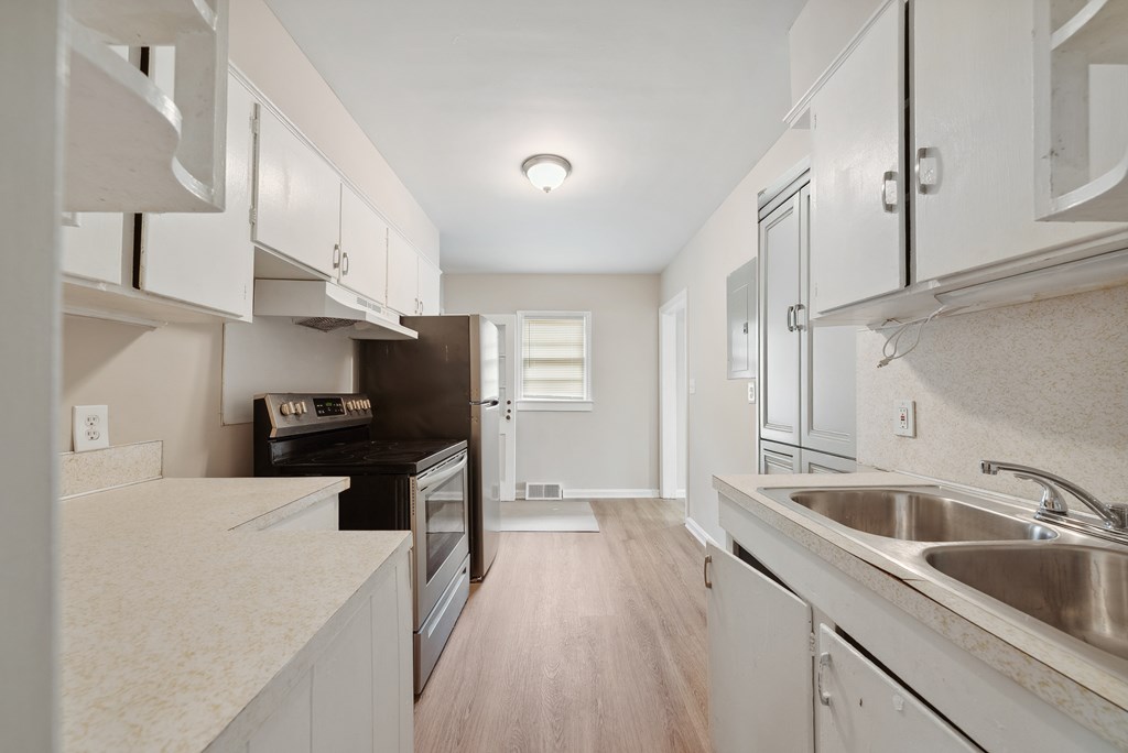 3127 8th Street Columbus, GA 31906 - Photo 13 of 14 a kitchen with a sink a stove and cabinets