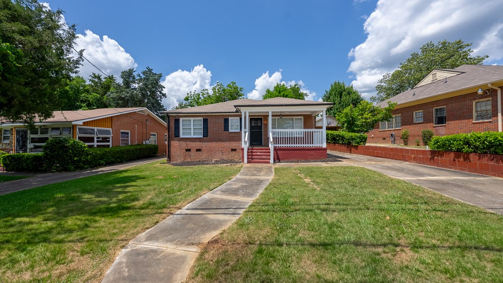 3127 8th Street Columbus, GA 31906 - Photo 2 of 14 a front view of a house with garden