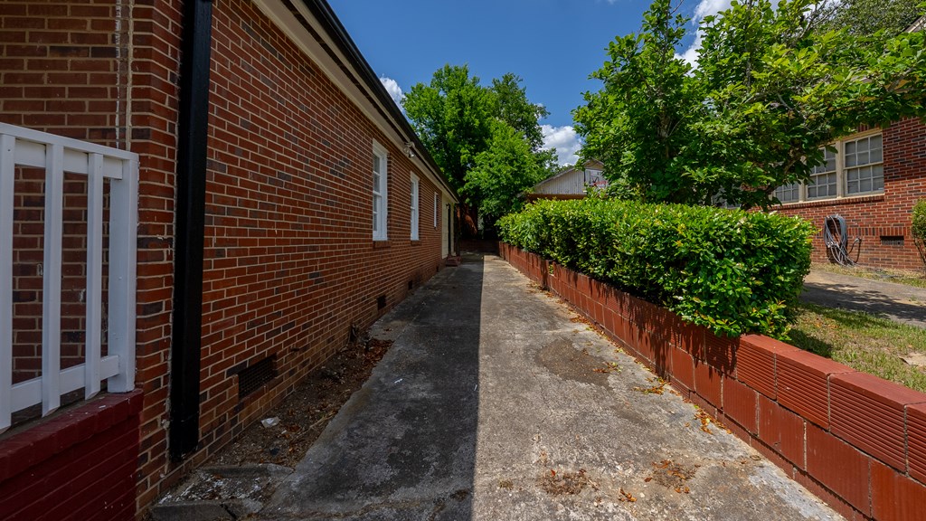 3127 8th Street Columbus, GA 31906 - Photo 4 of 14 a view of a pathway both side of house