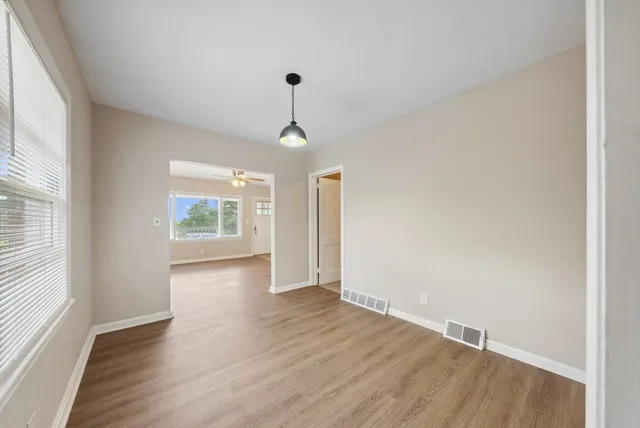 wooden floor in an empty room with a window