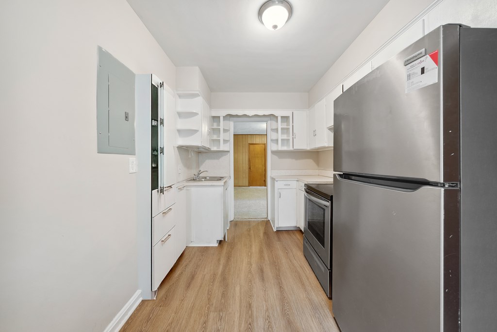 3127 8th Street Columbus, GA 31906 - Photo 10 of 14 a kitchen with a refrigerator a sink and dishwasher