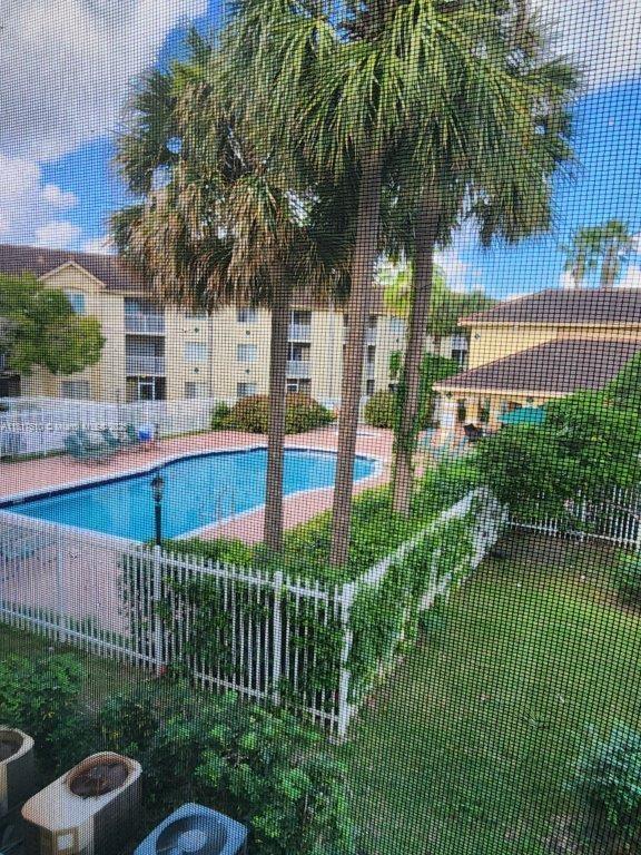 460 South Park Road, Unit 6209 Hollywood, FL 33021 - Photo 11 of 13 a view of a house with a yard and potted plants