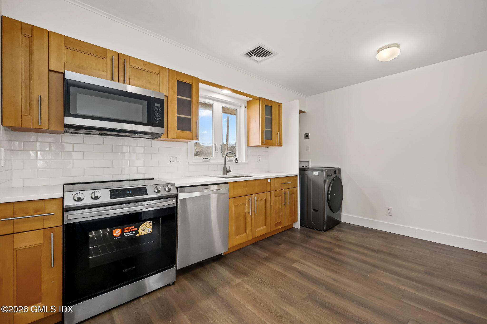 2 Grange Street Greenwich, CT 06830 - Photo 5 of 31 a kitchen with stainless steel appliances a stove a microwave and sink