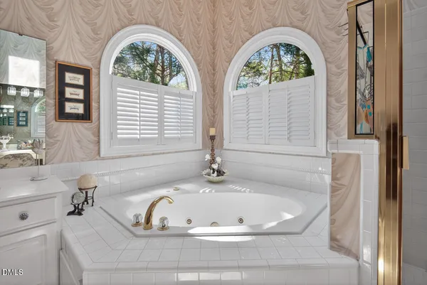 a bath tub sitting in a bathroom next to a window