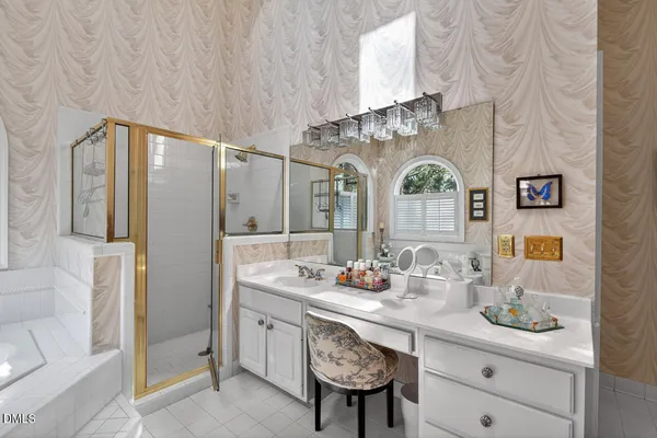 a bathroom with a granite countertop sink a toilet and shower