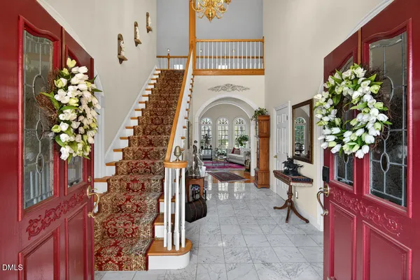 a living room with patio furniture and a potted plant