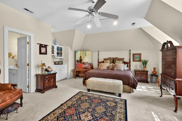 a bedroom with furniture and a chandelier
