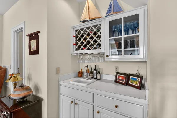 a kitchen with a white cabinets and window