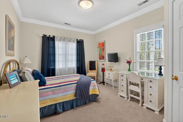 a bedroom with furniture and a window