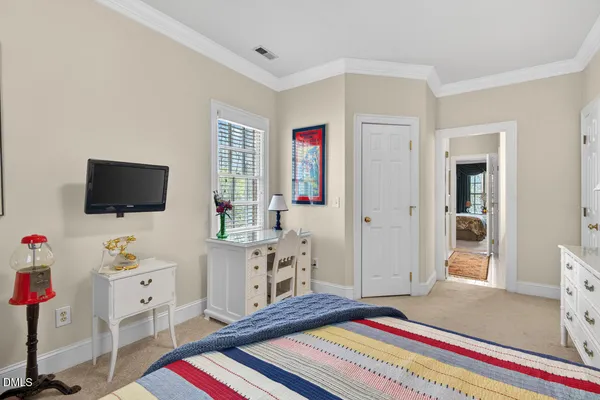 a bedroom with furniture and a flat screen tv