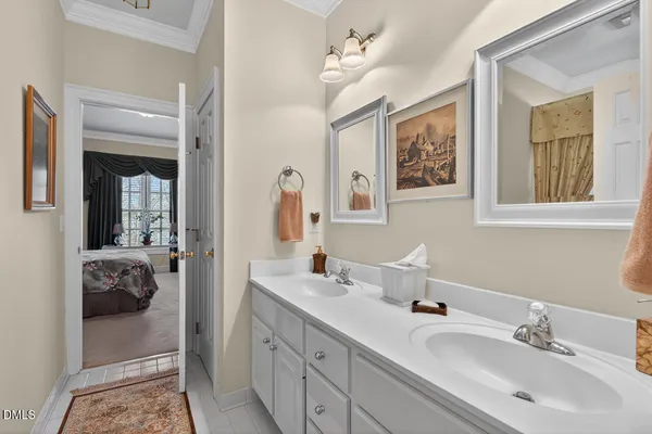 a en suite bathroom with double vanity sinks a mirror and a shower