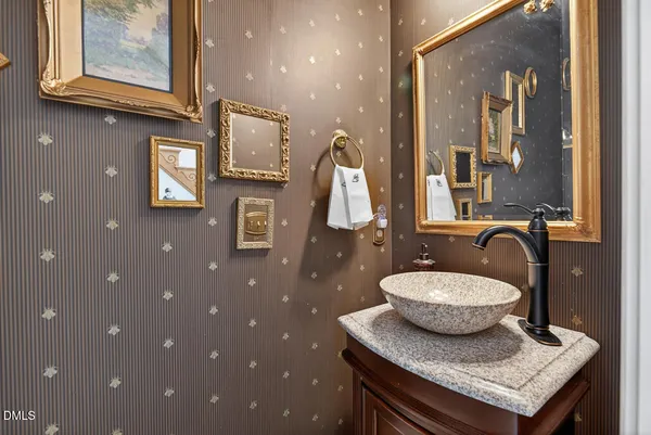 a bathroom with a granite countertop sink a toilet and mirror
