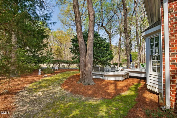 a view of a house with a wooden fence