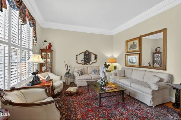 a living room with furniture a rug and a window