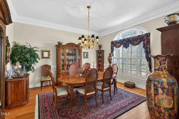 a view of a dining room with furniture and chandelier