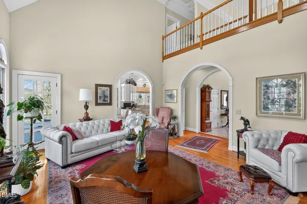 a living room with furniture potted plant and a large window