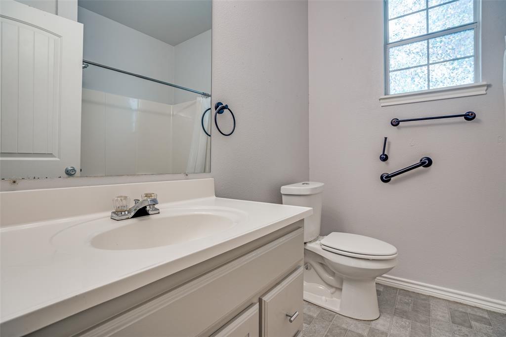 1503 Cherry Street Gainesville, TX 76240 - Photo 11 of 20 a bathroom with a sink toilet and shower