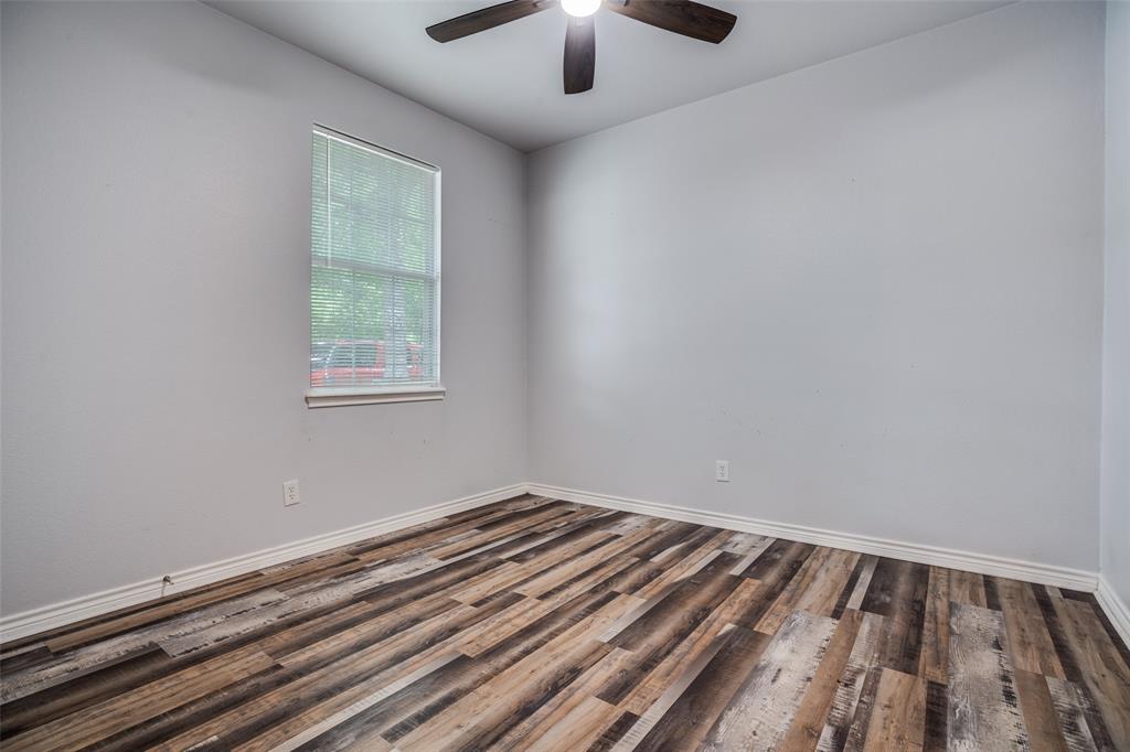 1503 Cherry Street Gainesville, TX 76240 - Photo 12 of 20 wooden floor in a room next to a window