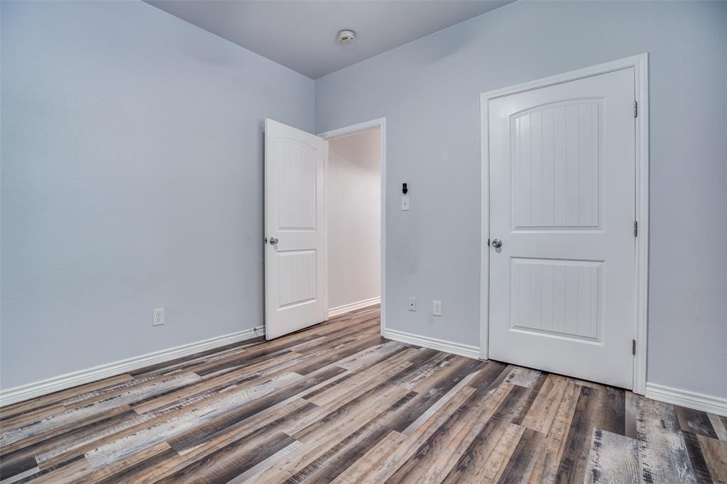 1503 Cherry Street Gainesville, TX 76240 - Photo 13 of 20 a view of an empty room with wooden floor