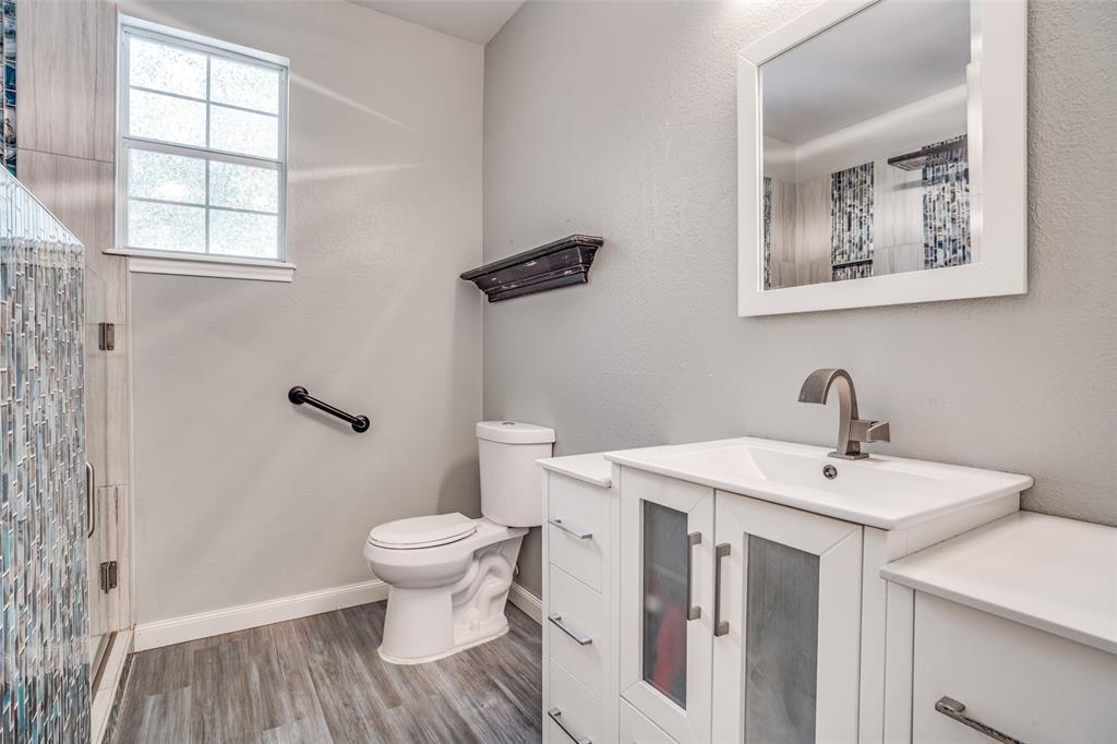 1503 Cherry Street Gainesville, TX 76240 - Photo 16 of 20 a bathroom with a sink mirror and toilet