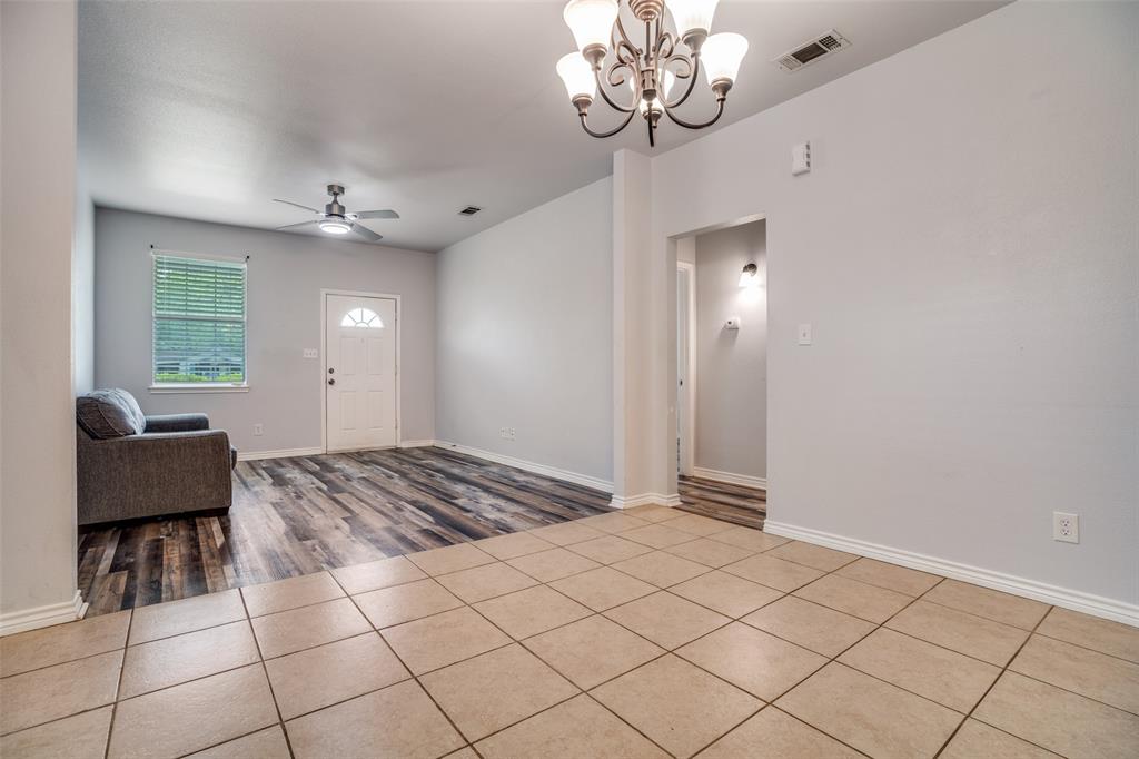 1503 Cherry Street Gainesville, TX 76240 - Photo 5 of 20 a view of a livingroom with a chandelier furniture and windows