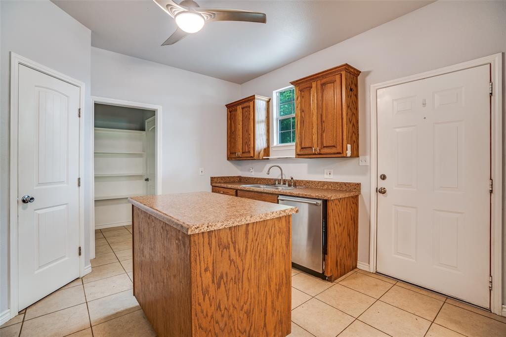 1503 Cherry Street Gainesville, TX 76240 - Photo 7 of 20 a bathroom with a sink a mirror and a shower