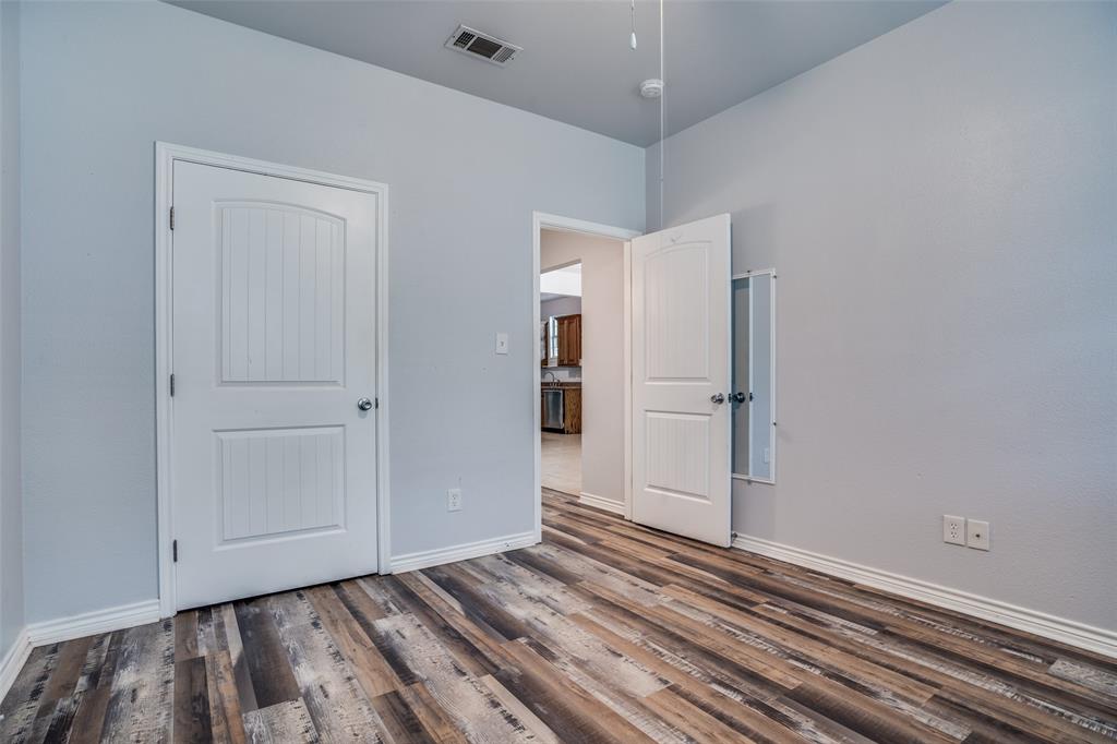 1503 Cherry Street Gainesville, TX 76240 - Photo 10 of 20 a view of an empty room with closet and wooden floor