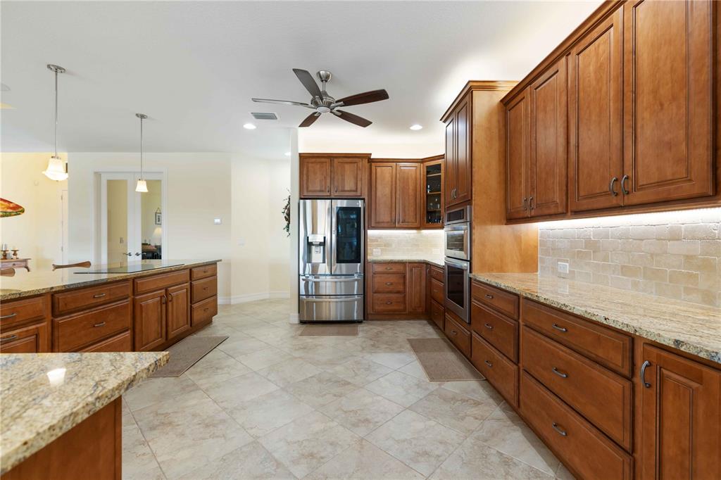 11626 Bridle Path Lane Placida, FL 33946 - Photo 15 of 51 a large kitchen with stainless steel appliances granite countertop a sink counter space cabinets and a large window